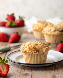 Strawberry muffin on a white plate.