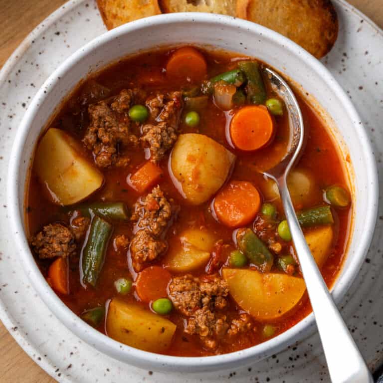 Hamburger soup served in a white bowl.