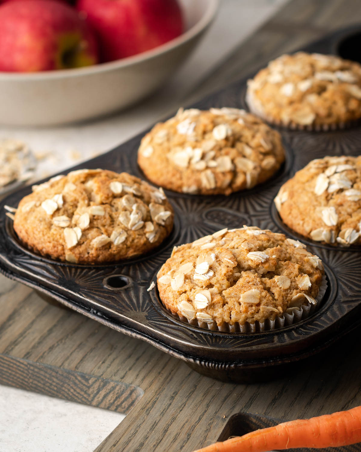 Freshly baked applesauce carrot muffins in a metal baking tin.