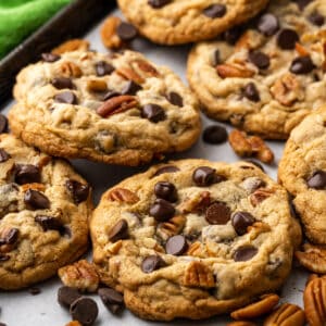 Closeup of pecan chocolate chip cookies on a baking tray.