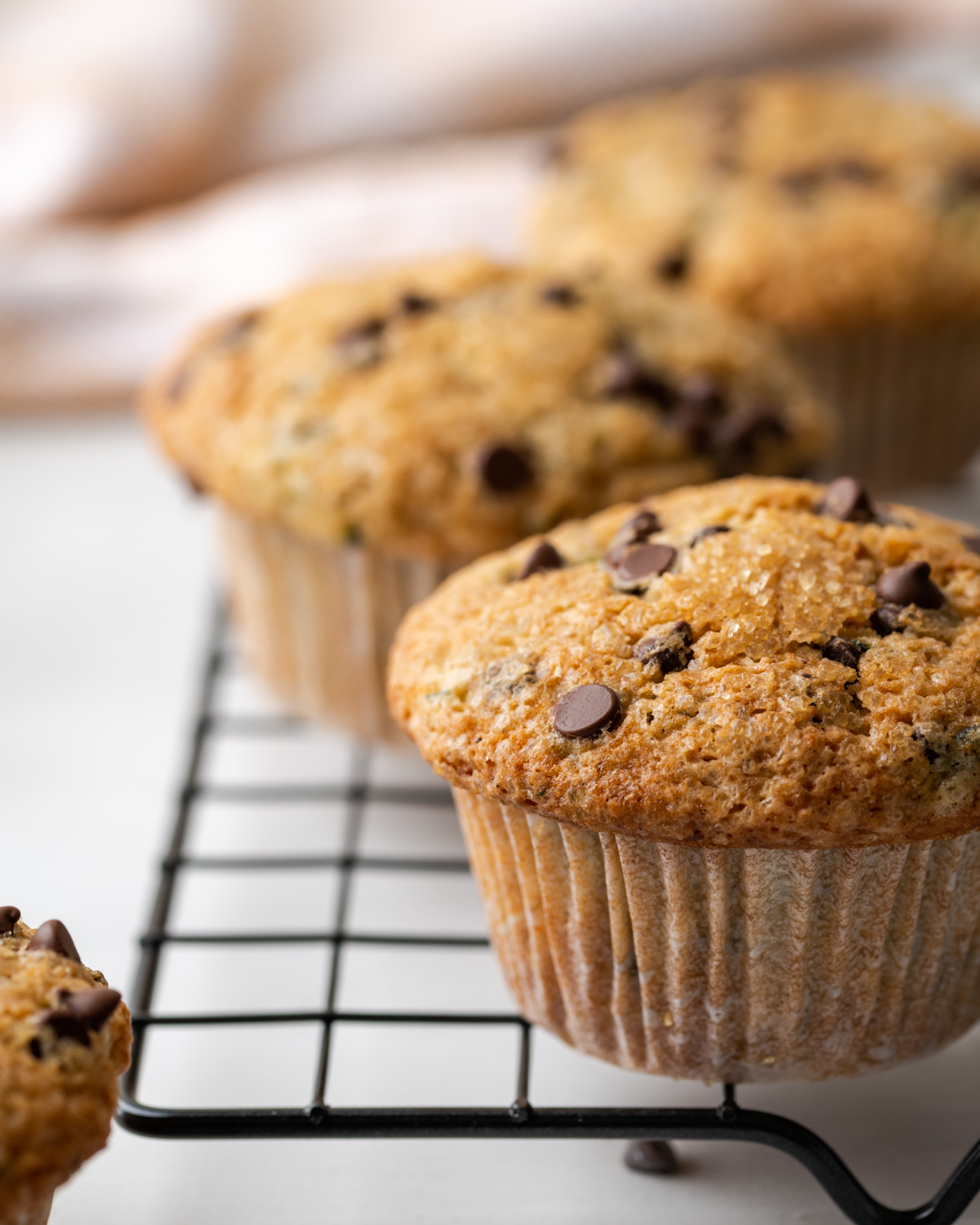 Zucchini chocolate chip muffins on a cooling rack.