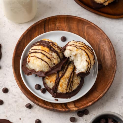 Three gluten free coconut macaroons on a small white plate.