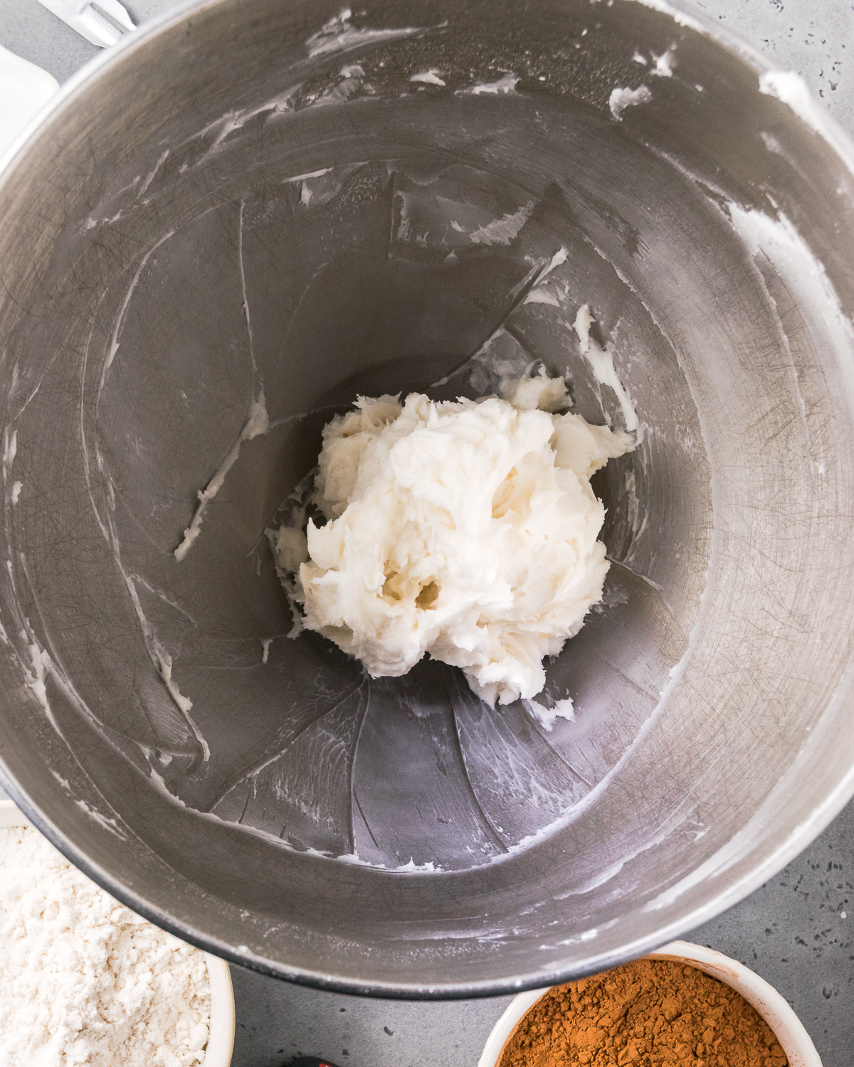 Butter and coconut oil creamed together in a large metal mixing bowl.