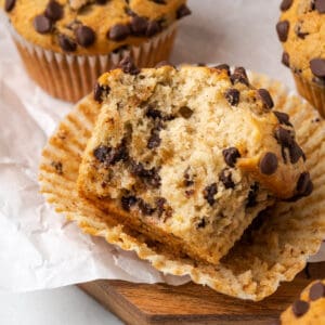 A closeup of a gluten free banana chocolate chip muffin with a bite taken out.