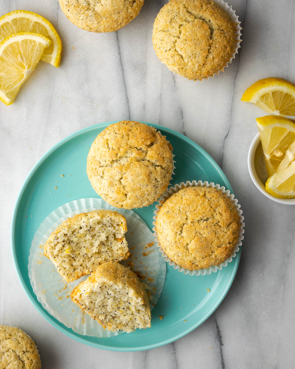 A sliced lemon poppy seed muffin on a blue plate.