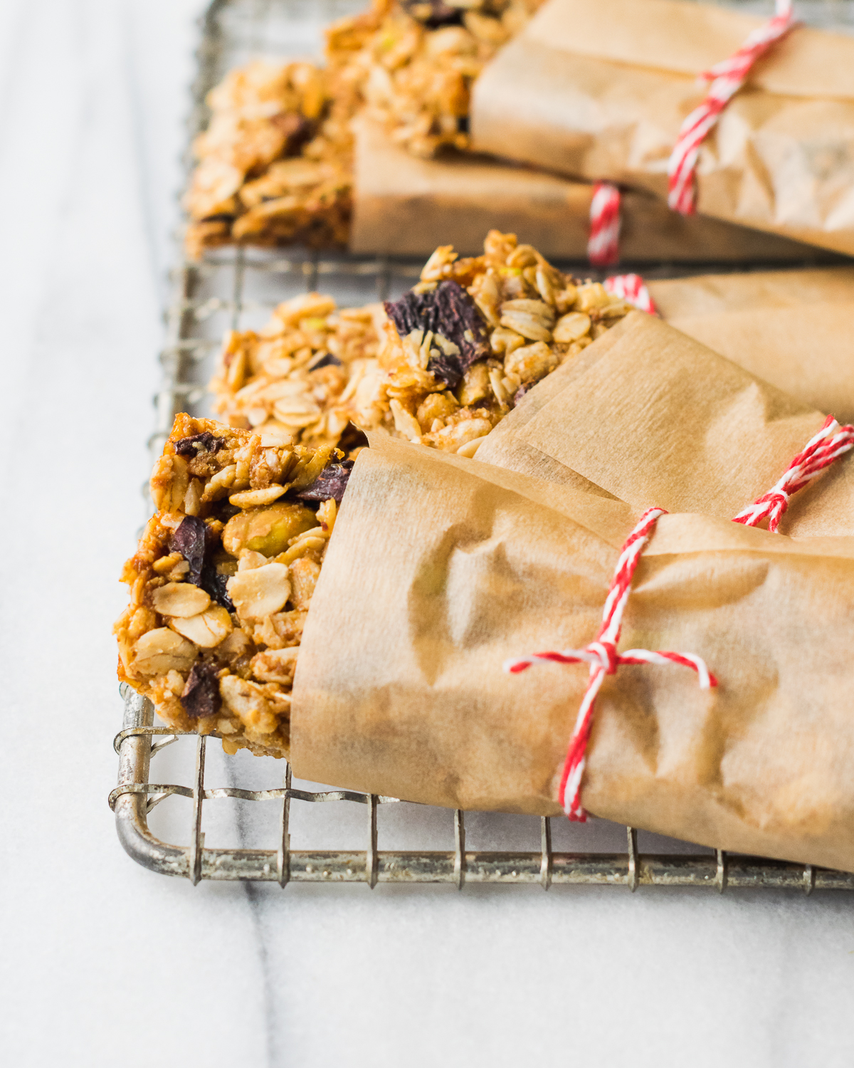 Homemade gluten free granola bars wrapped with paper and twine.