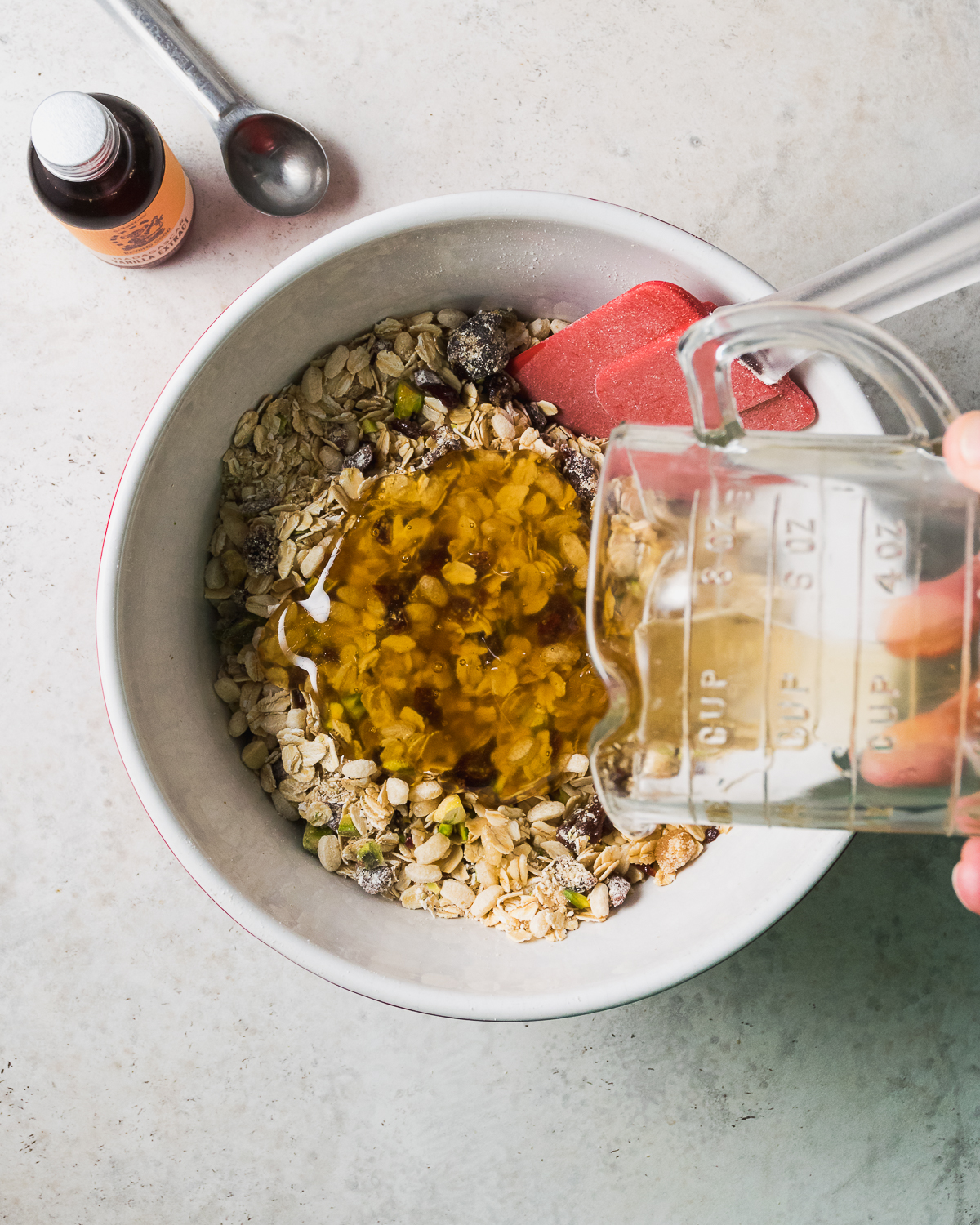 Honey being poured over mixed dry ingredients.