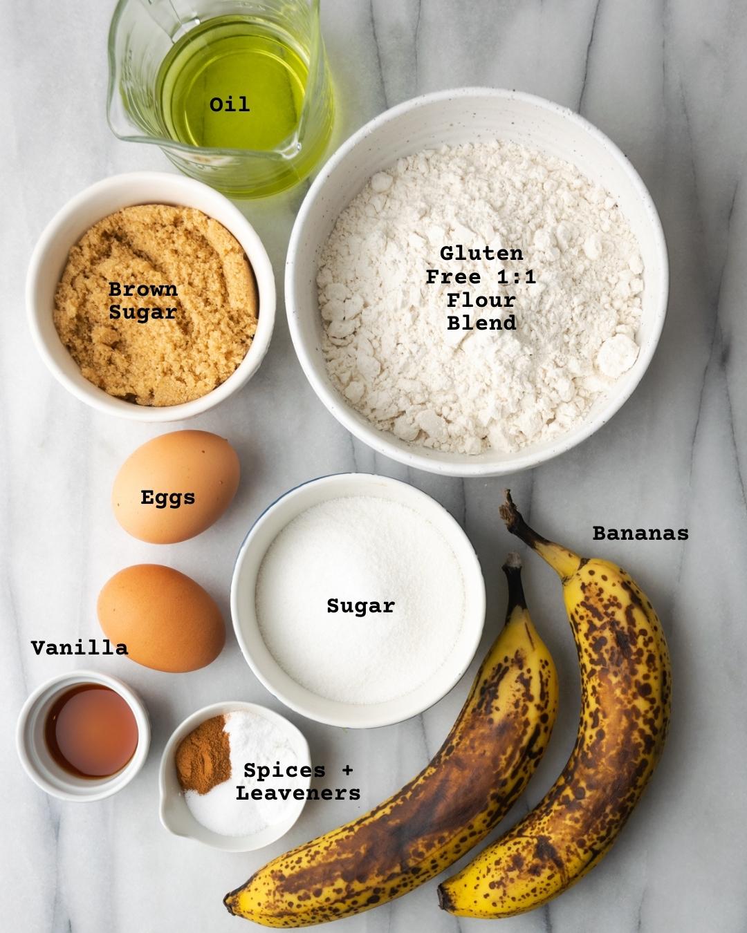 Ingredients for banana cake layer on a white marble table.