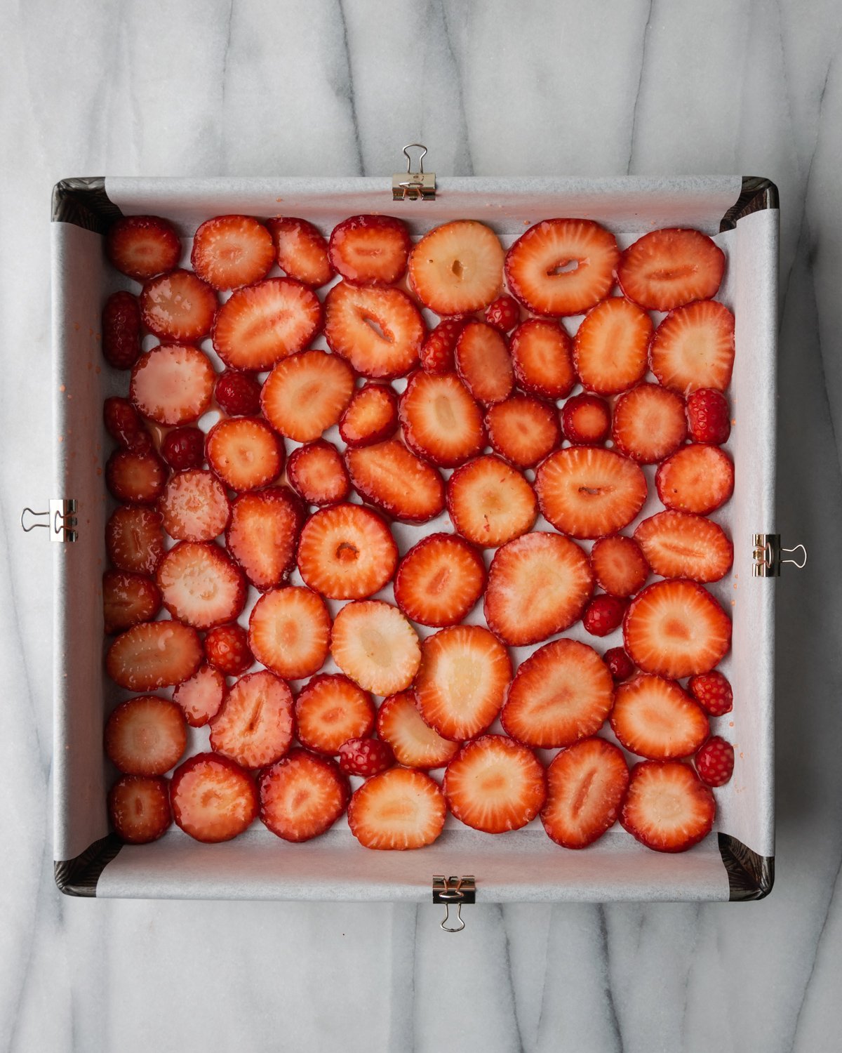 Sugar coated strawberries lining the bottom of the pan.