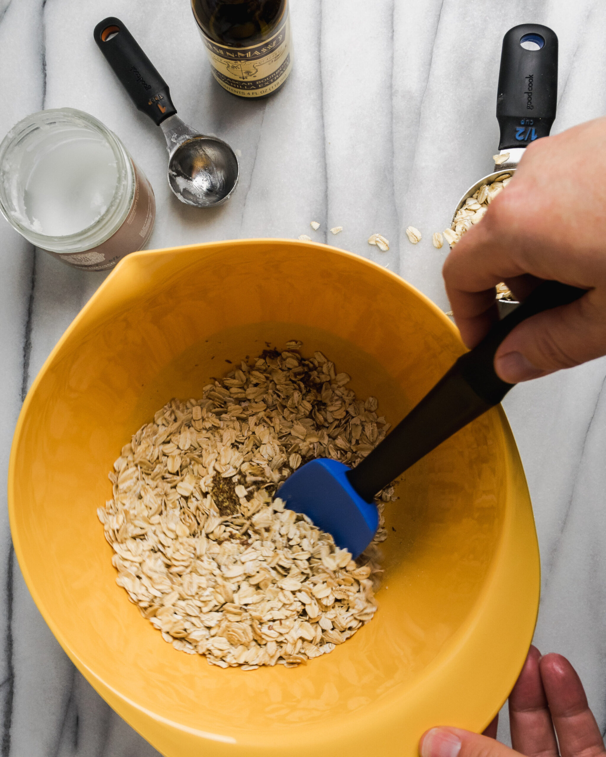 Granola ingredients being mixed in a bowl.