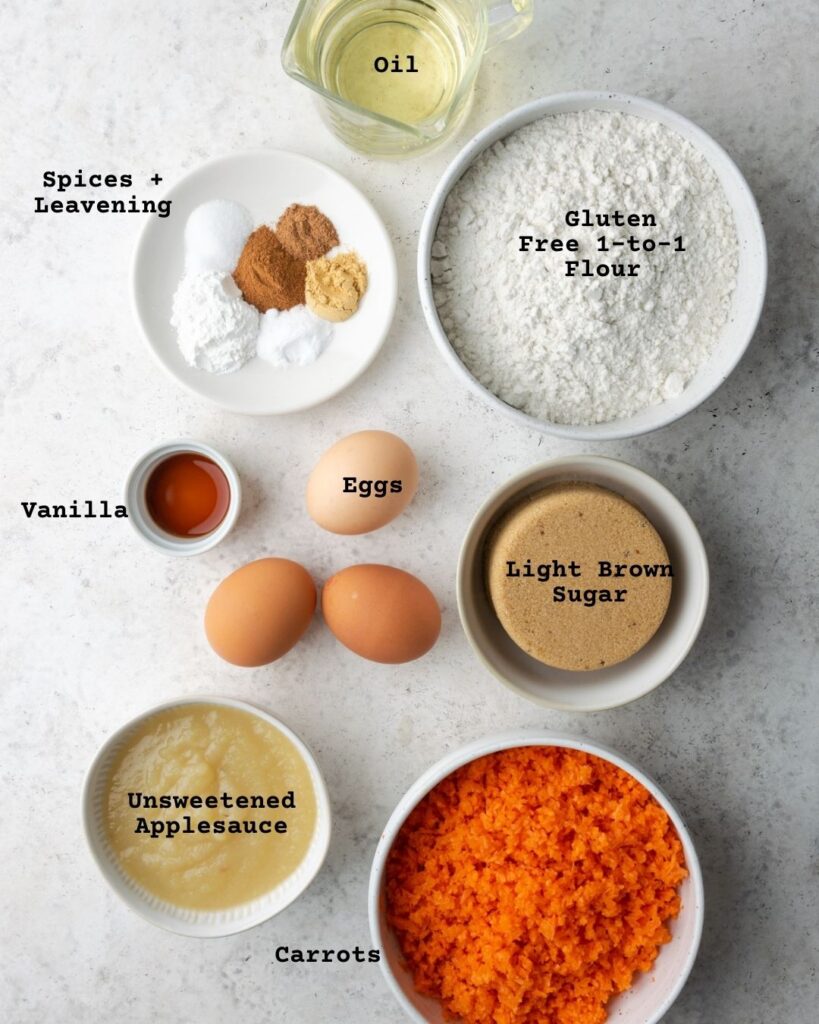 Ingredients for carrot coffee cake on a white table.