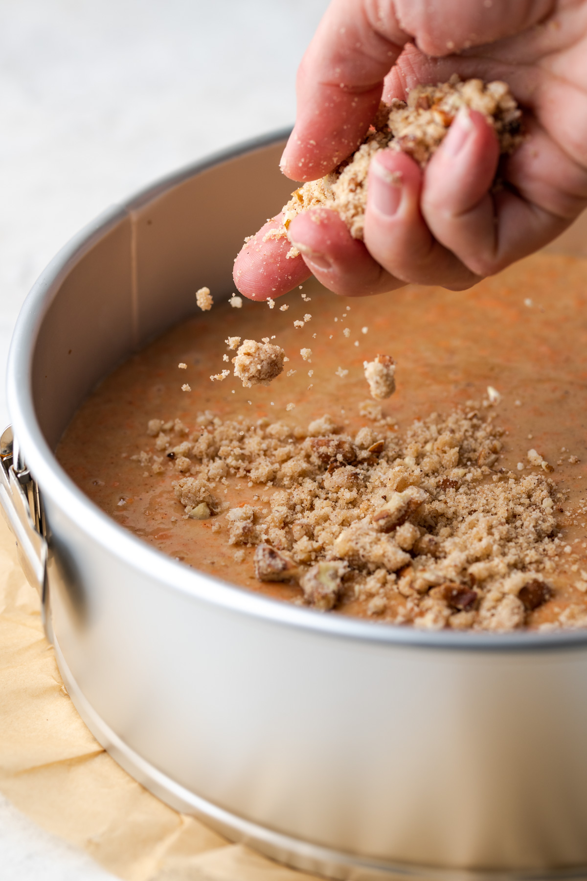 Handle sprinkling crumb topping on cake batter.