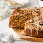 A sliced carrot cake coffee cake on a serving platter.