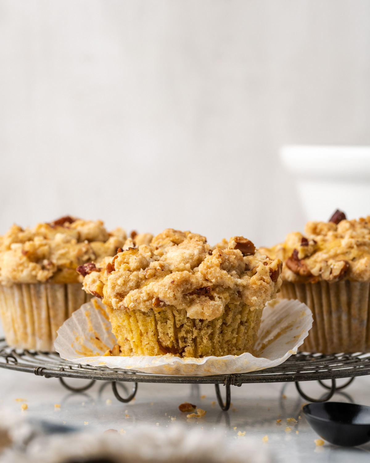 Closeup of gluten free peach muffins on a cooling rack.