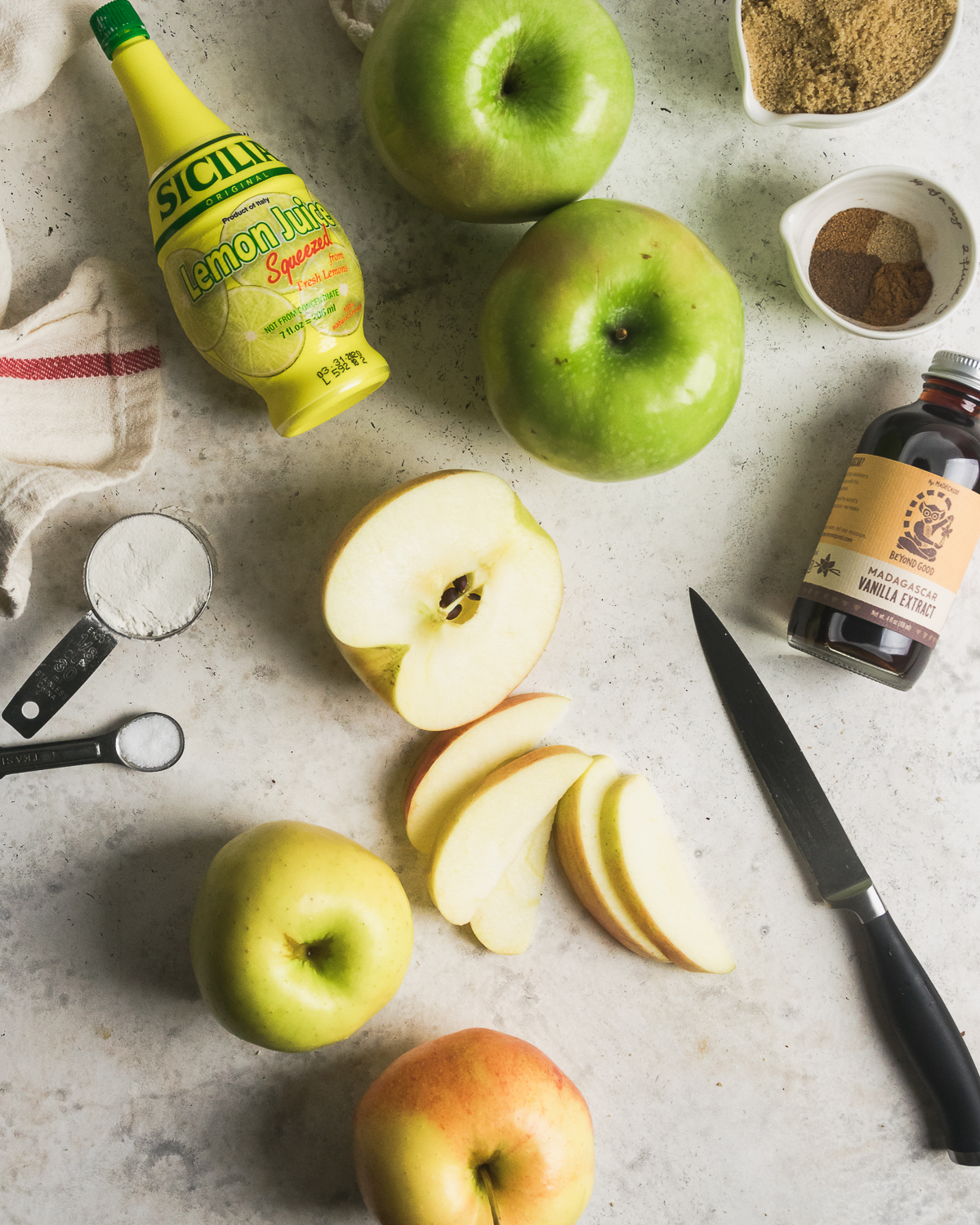 Ingredients for dutch apple pie filling on a white table.