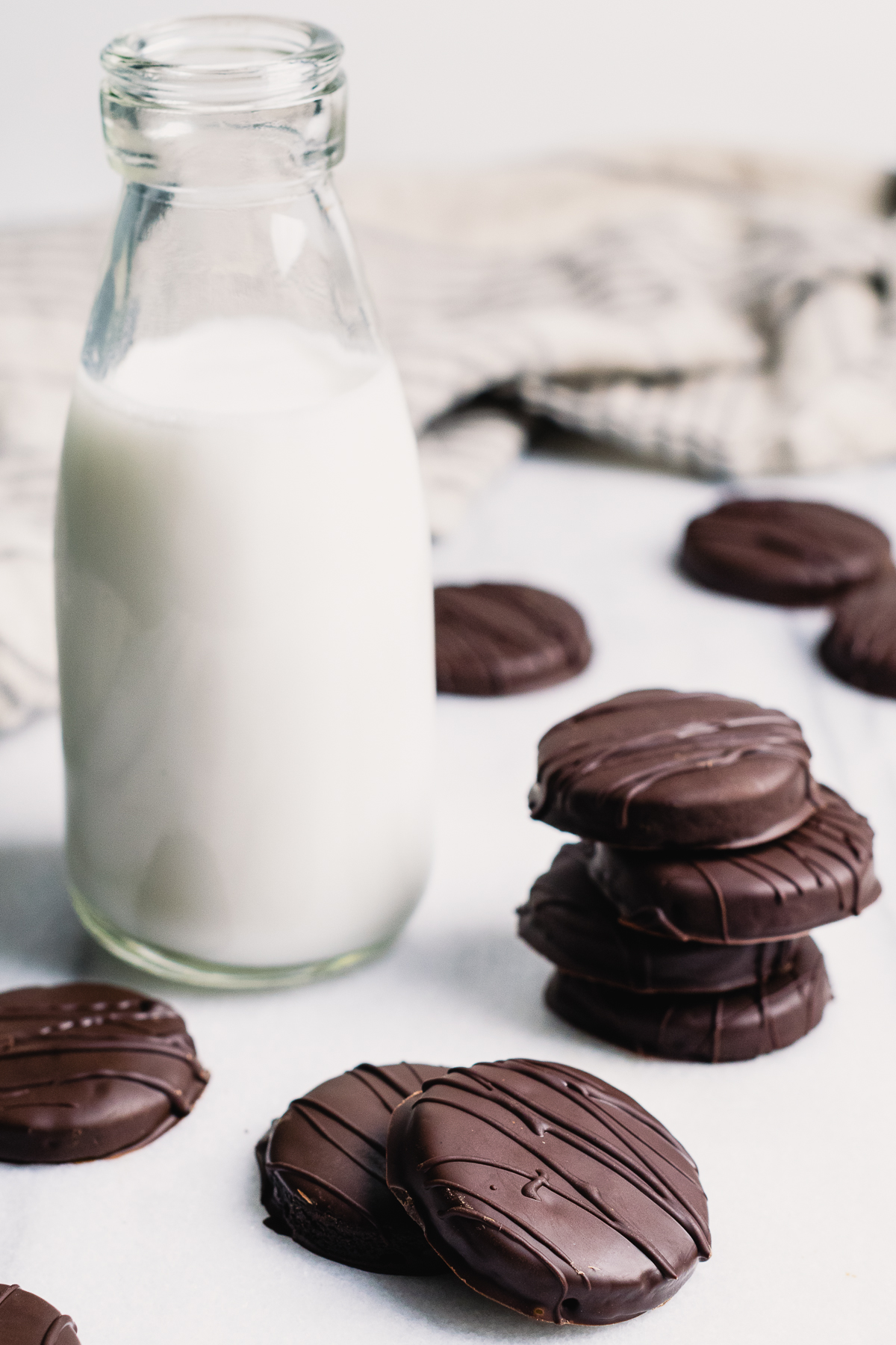 Gluten free thin mints scattered on a white table.