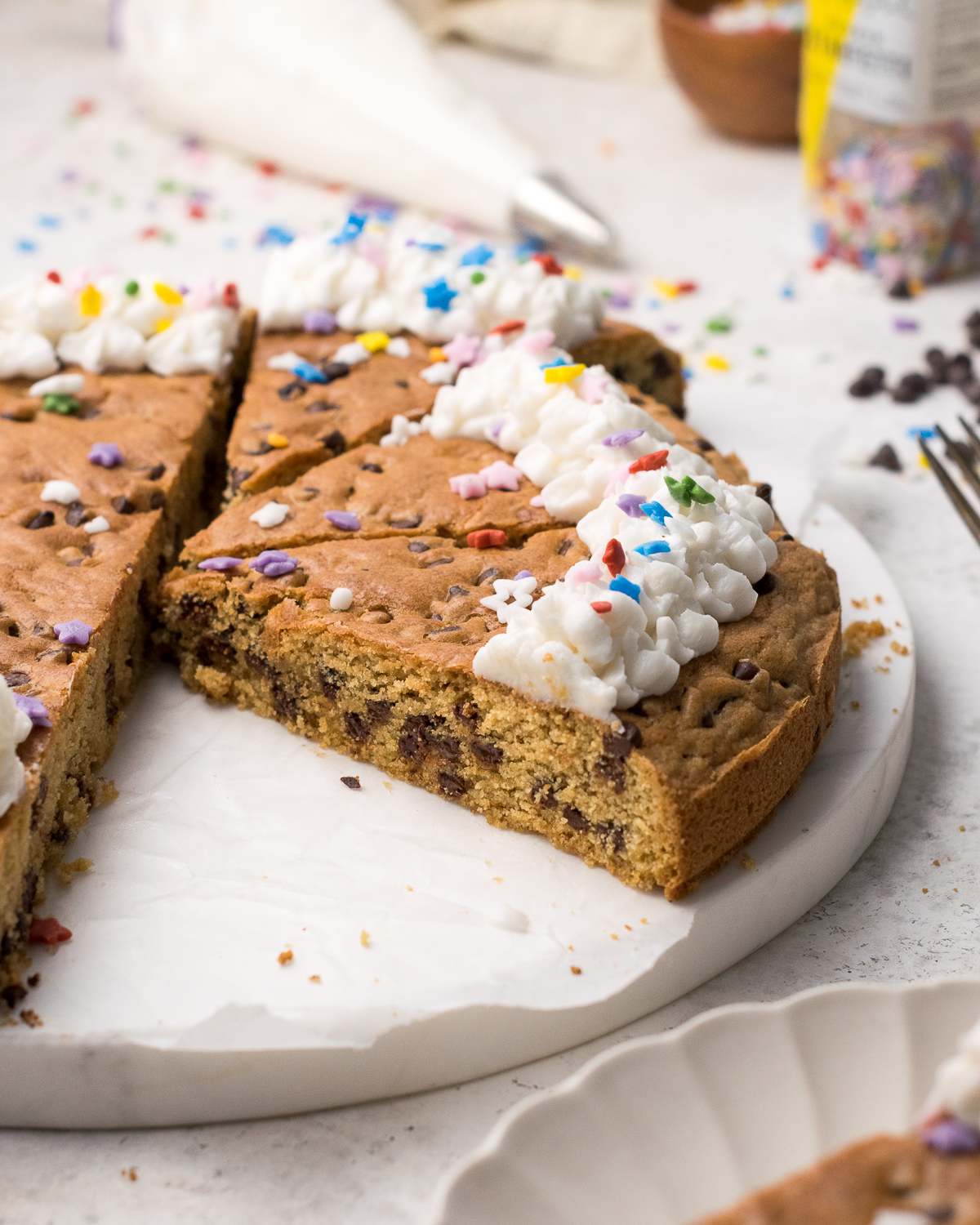 Cut cookie cake on a white tray.