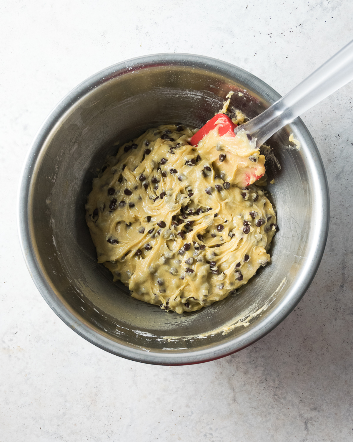 Cookie batter in a metal bowl.