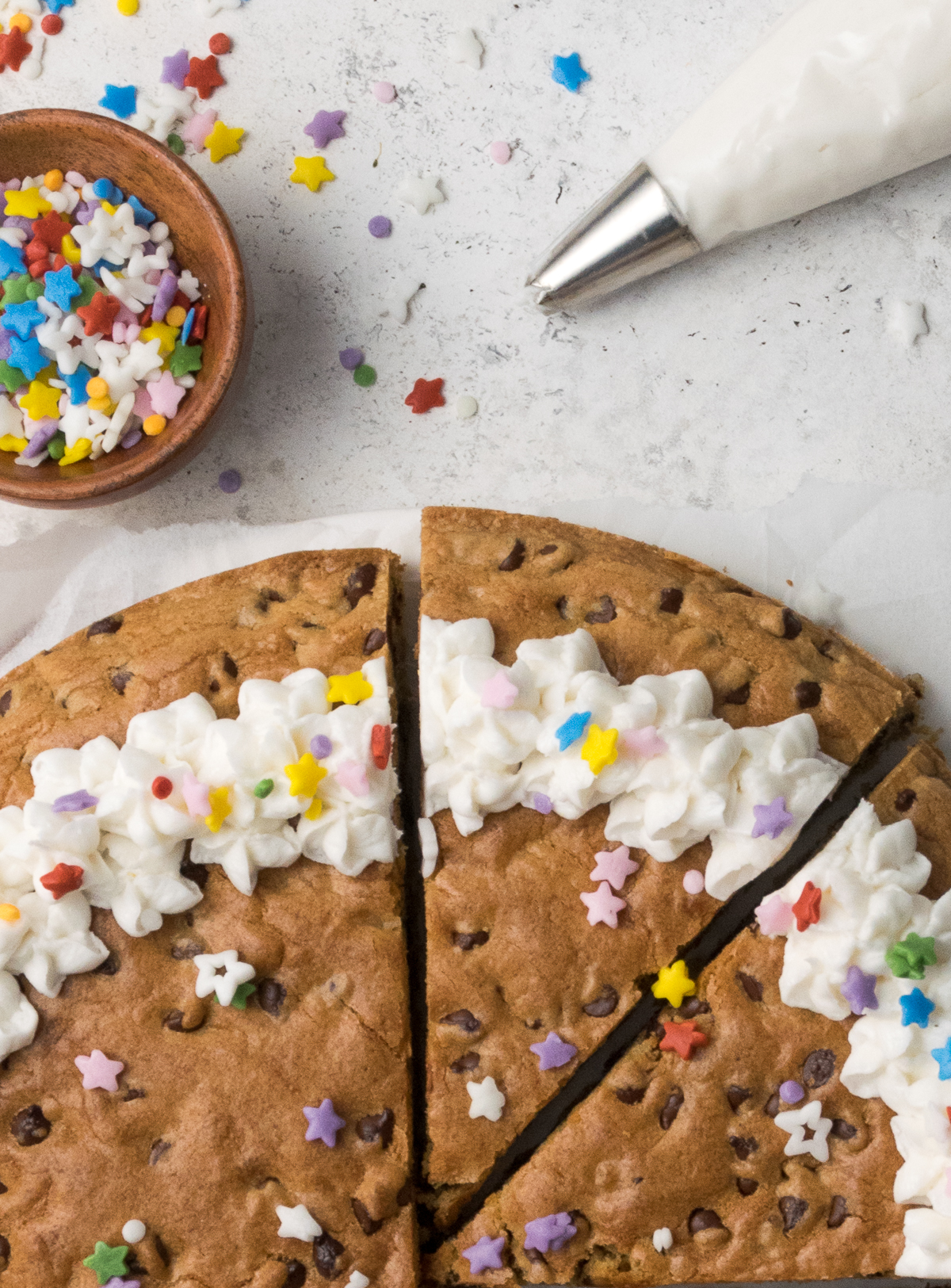 Slice cut from a gluten free cookie cake on table.