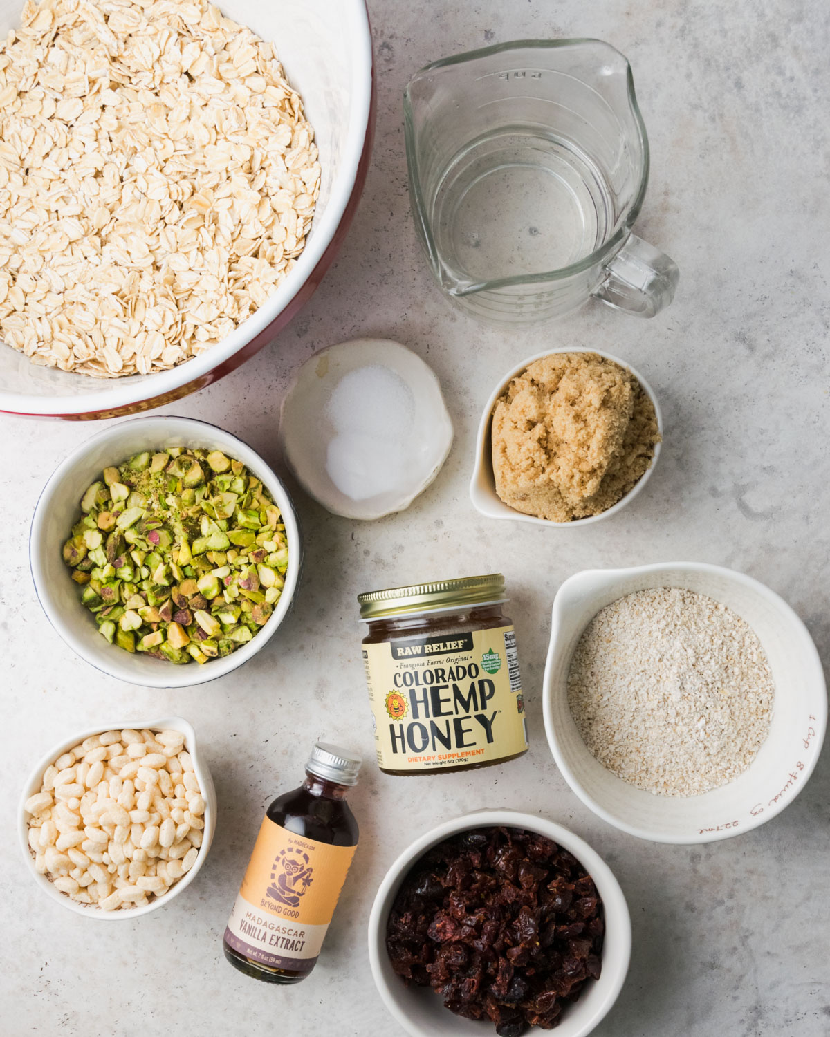 Ingredients for gluten free granola bars on a white table.