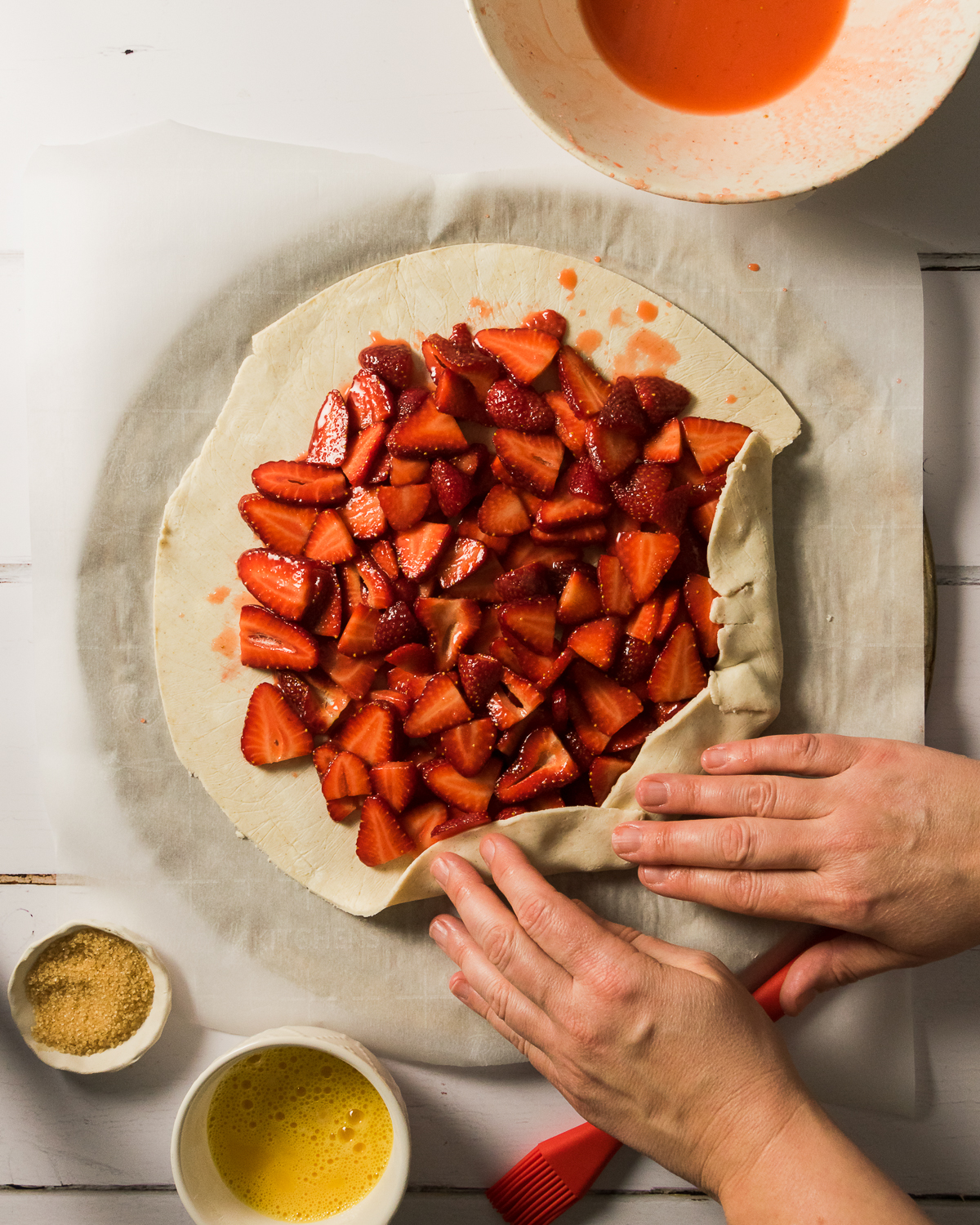 Pie dough being folded into the center to make a galette crust.