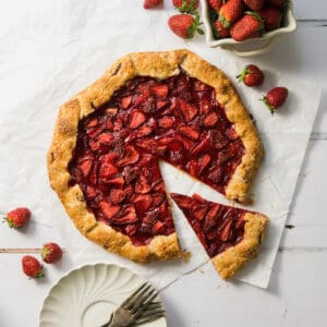 Sliced strawberry galette on a white table.