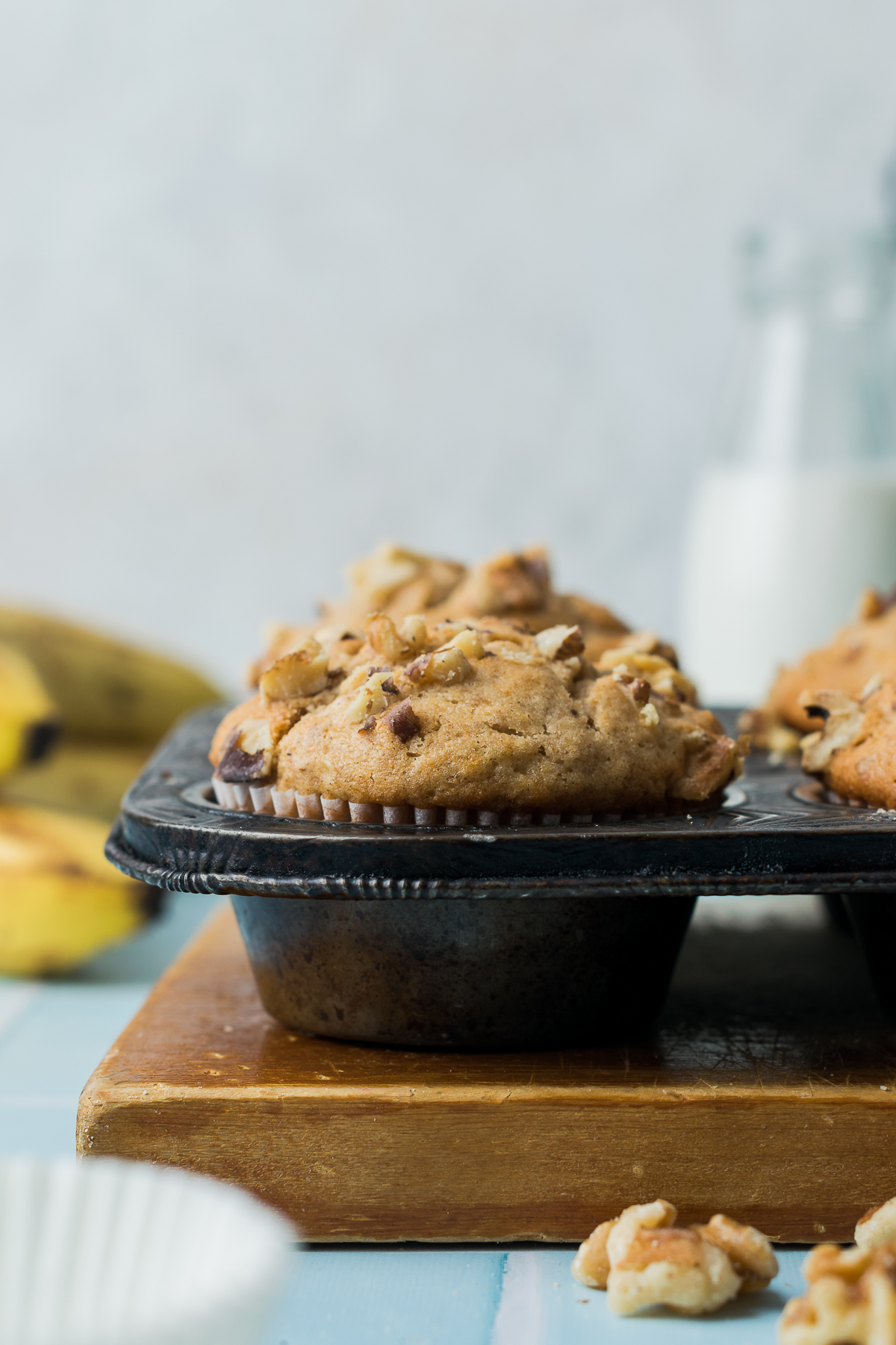 Freshly baked gluten free banana muffins in a metal baking tin.
