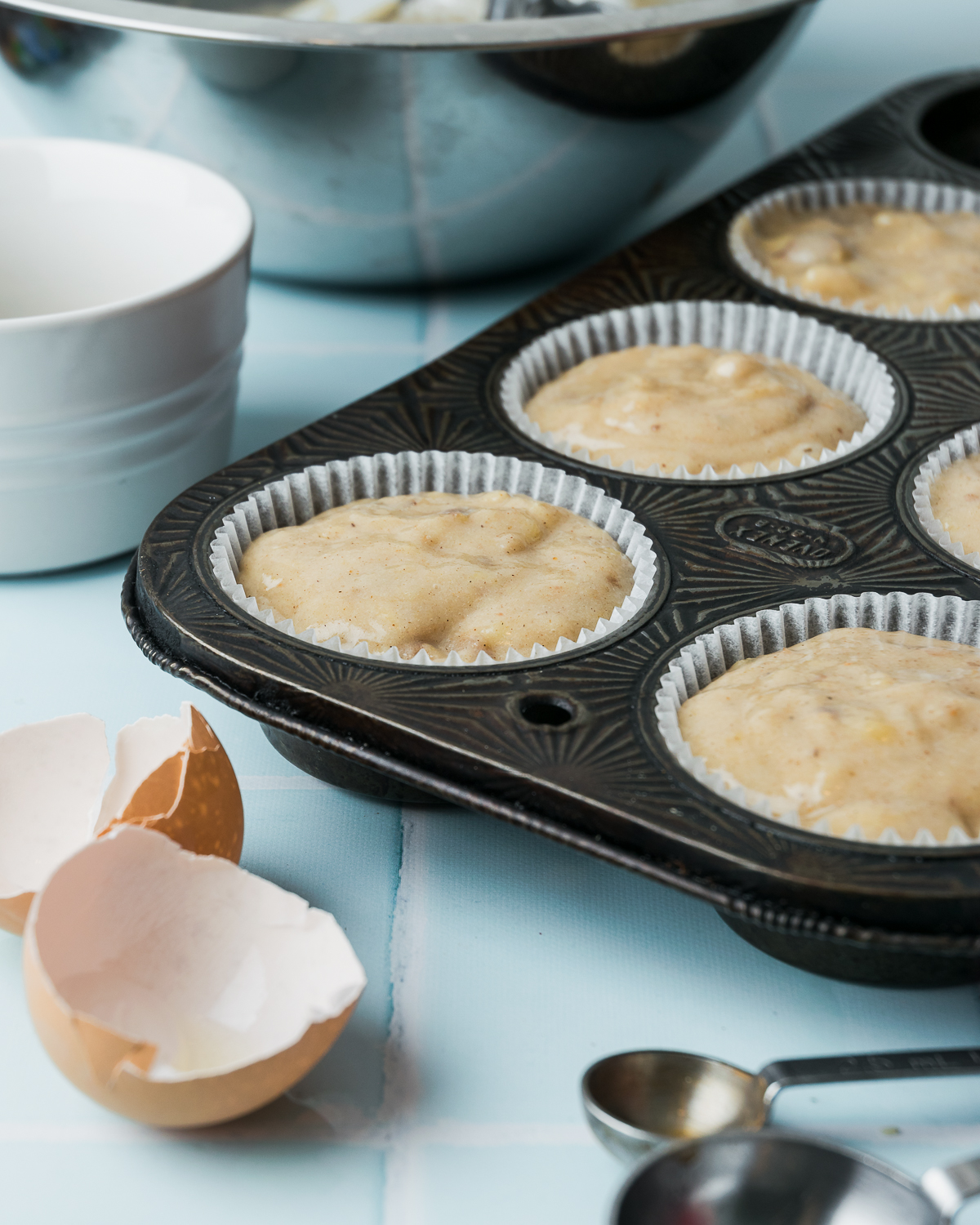 Unbaked banana muffin batter in a tin.