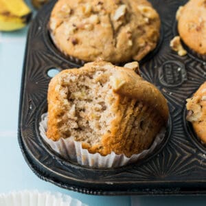 A closeup of a banana nut muffin with a bite taken out.