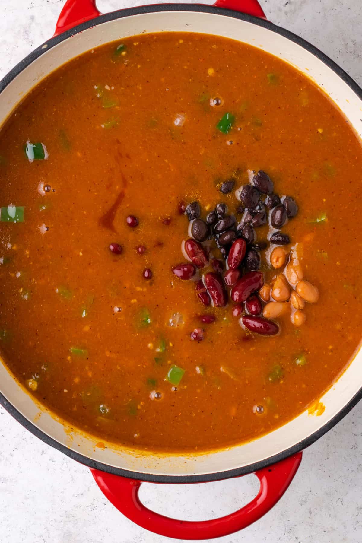 Beans being added to the soup pot.