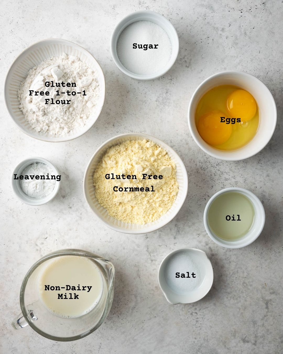 Ingredients for gluten free cornbread muffins on white table.