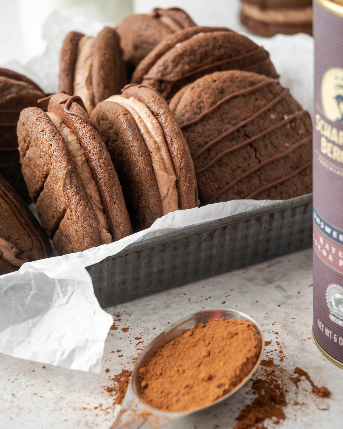 A metal tray filled with homemade fudge rounds and surrounded by baking ingredients.