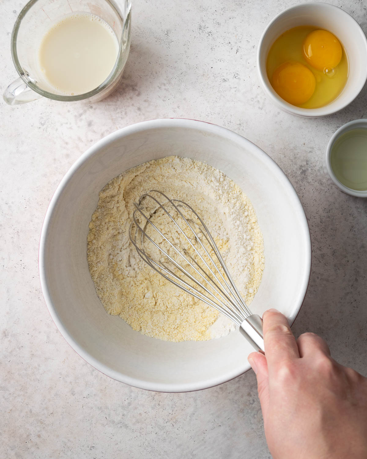 Dry ingredients being whisked in a large bowl.