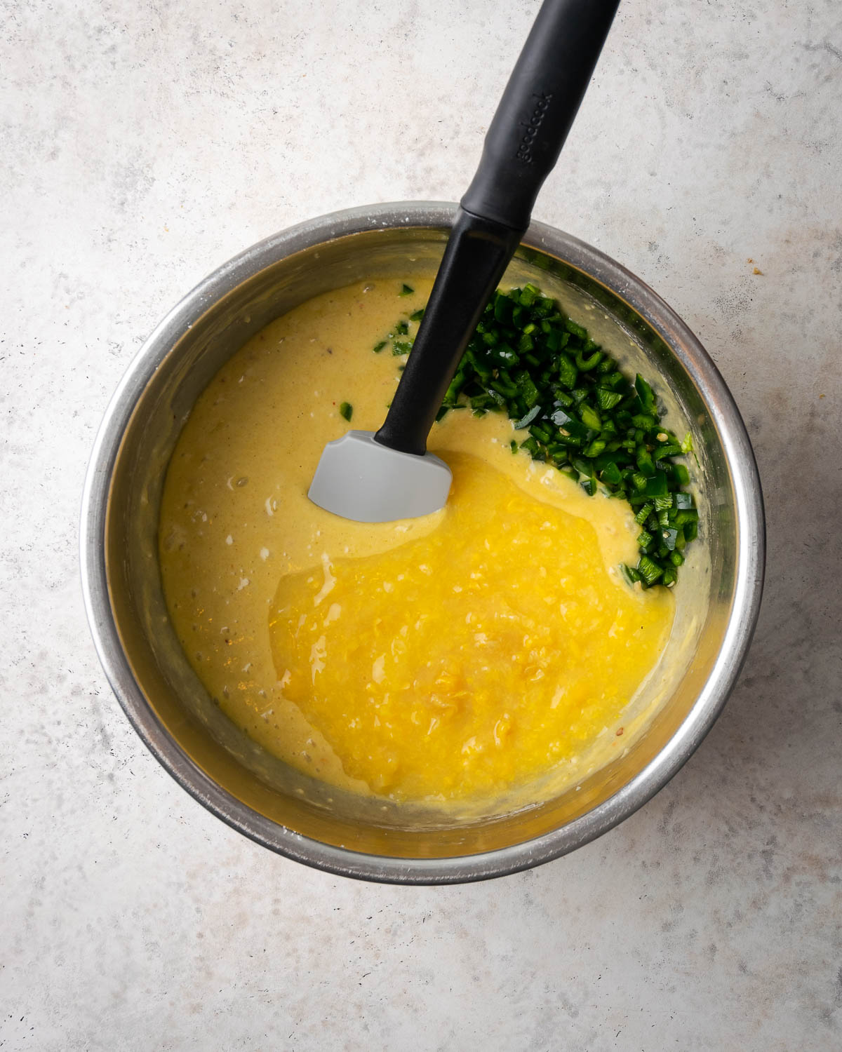 Creamed corn and poblano peppers added to the partially mixed corn casserole batter.