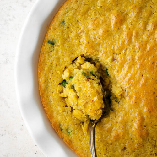 A spoonful of corn pudding being served.