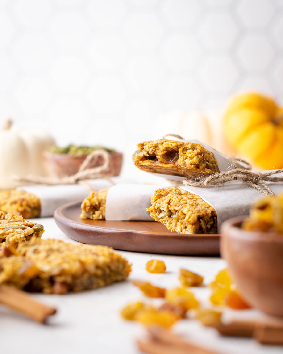 Gluten free pumpkin granola bars stacked on a wooden plate.