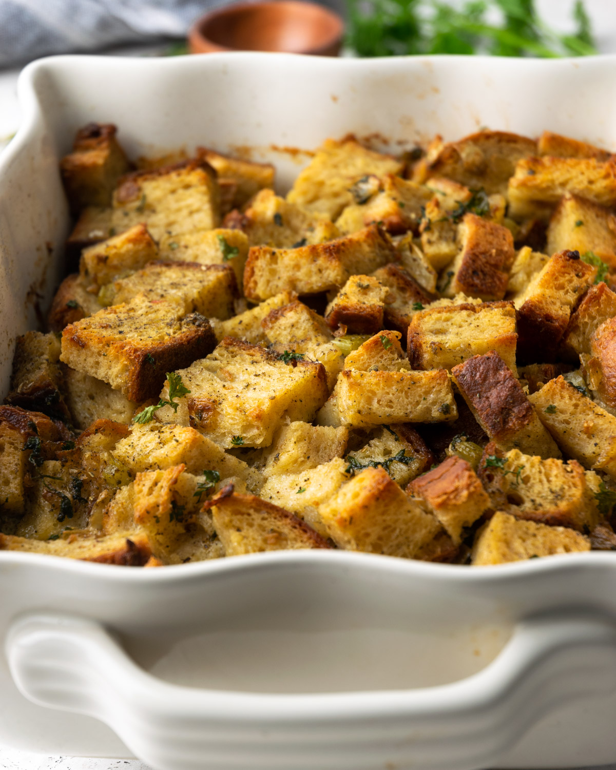 A casserole dish filled with golden brown baked stuffing.