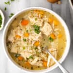 Chicken and rice soup in a white bowl.