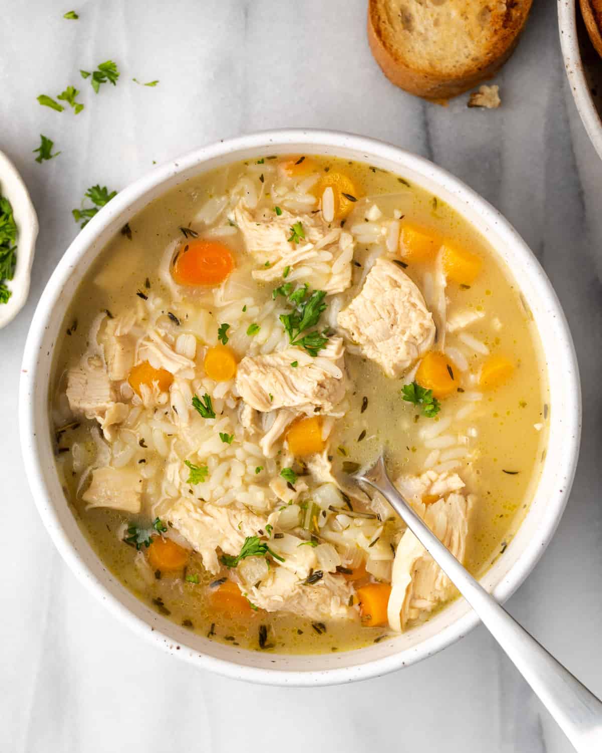 Chicken and rice soup in a white bowl.