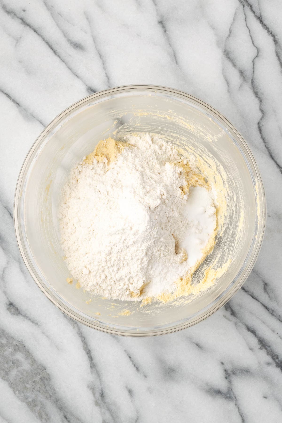 Gluten free flour, baking powder, baking soda, and salt added to the partially mixed cookie dough.