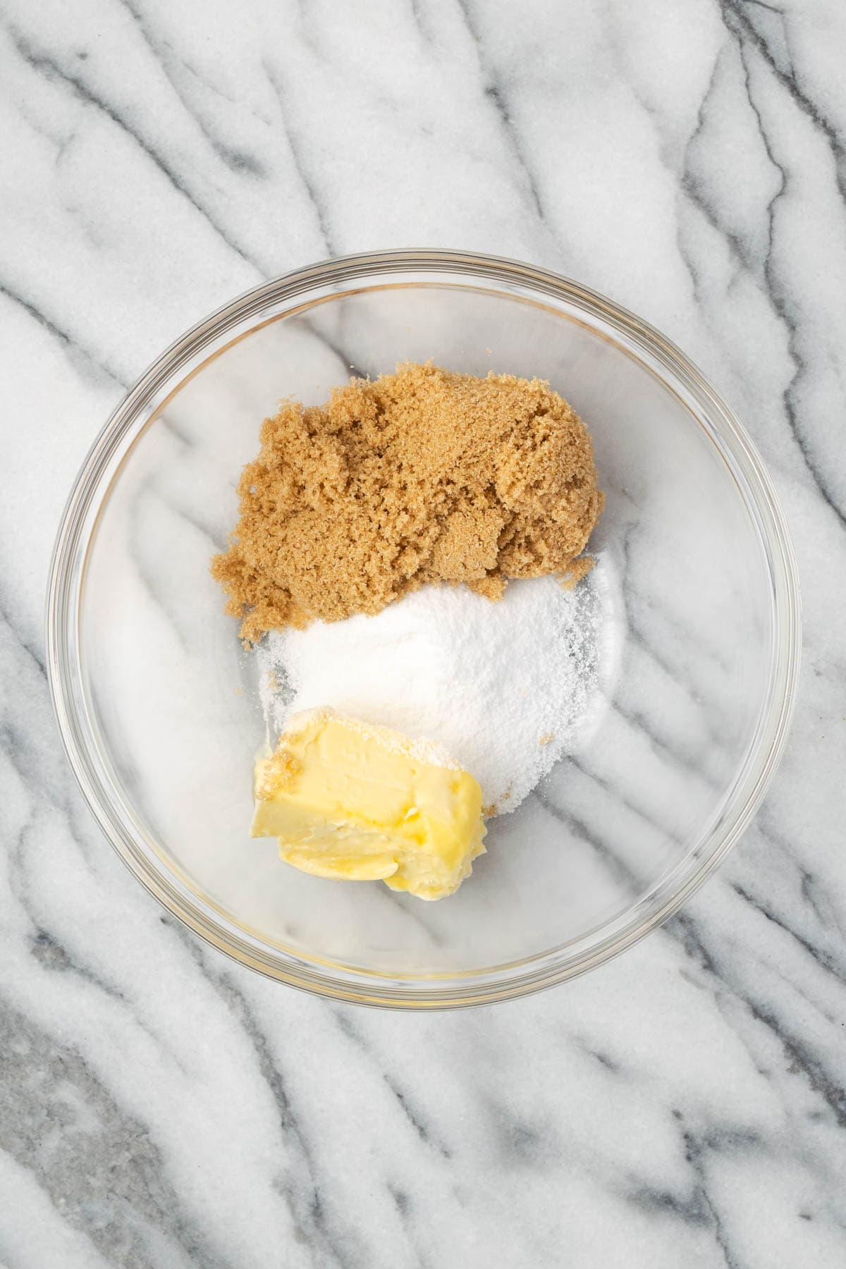 Brown sugar, granulated sugar and butter in a mixing bowl. 