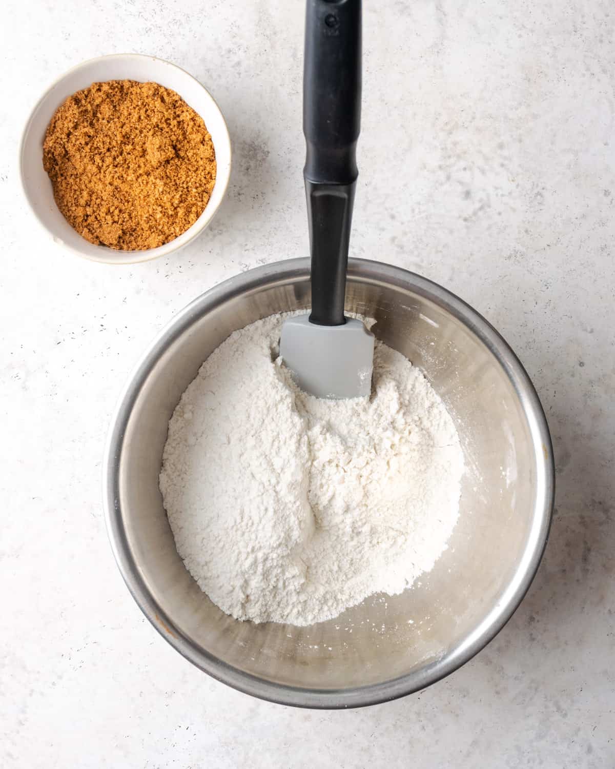 Gluten free flour, baking powder, sugar and salt combined together in a large metal mixing bowl.