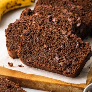 A closeup of slices of chocolate banana bread on a cutting board.