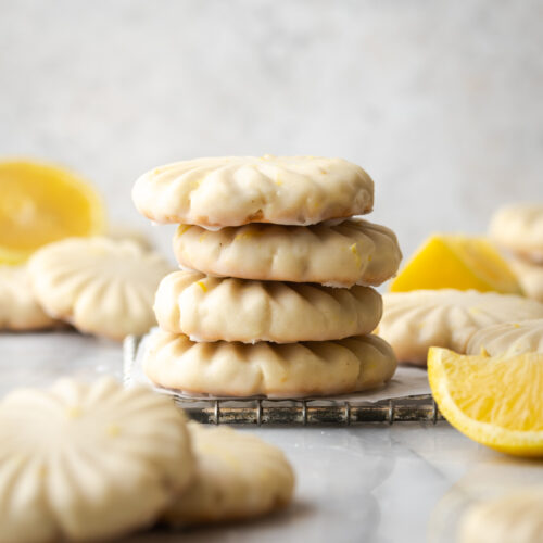 Lemon cookies stacked on a table.