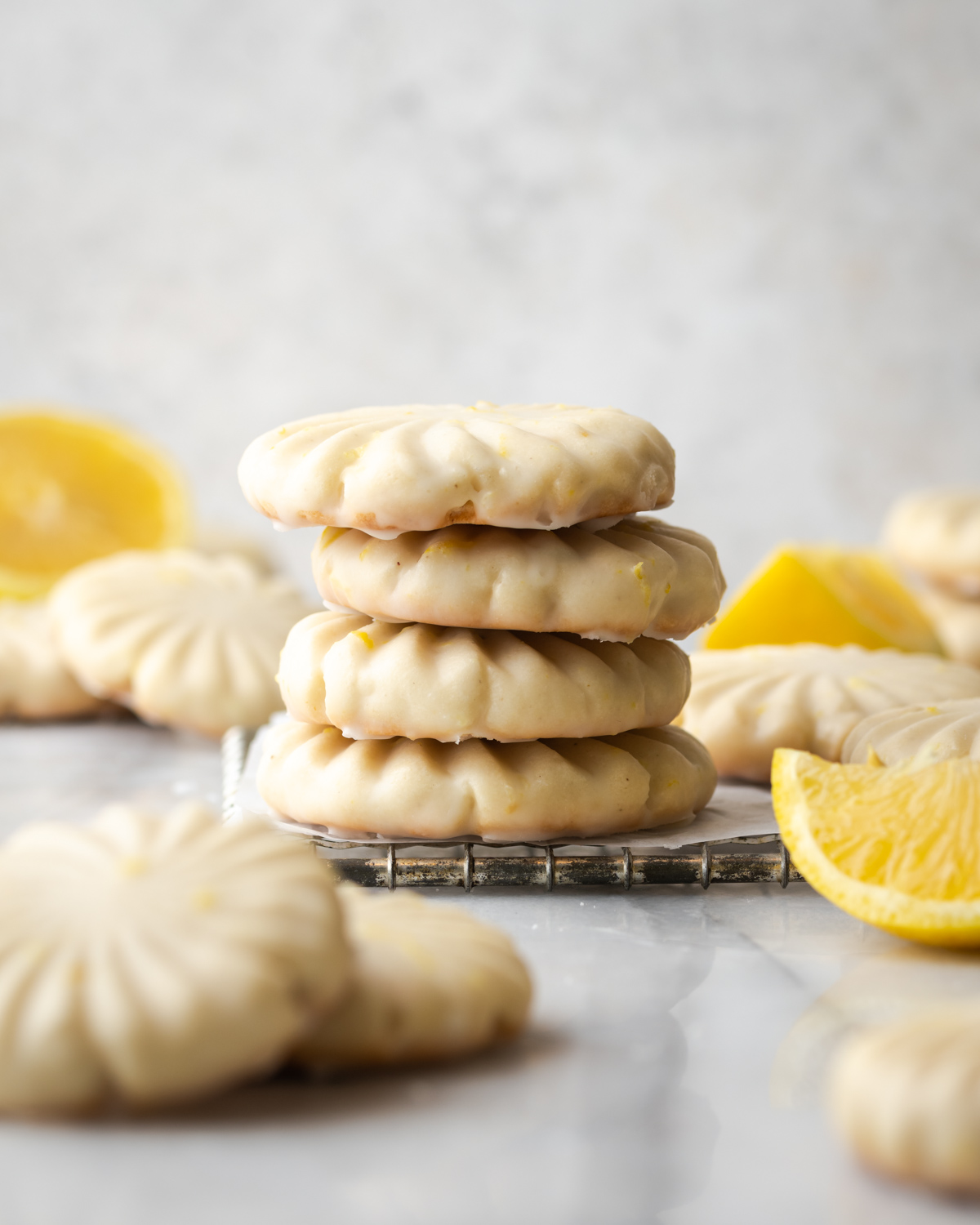 Lemon cookies stacked on a table.