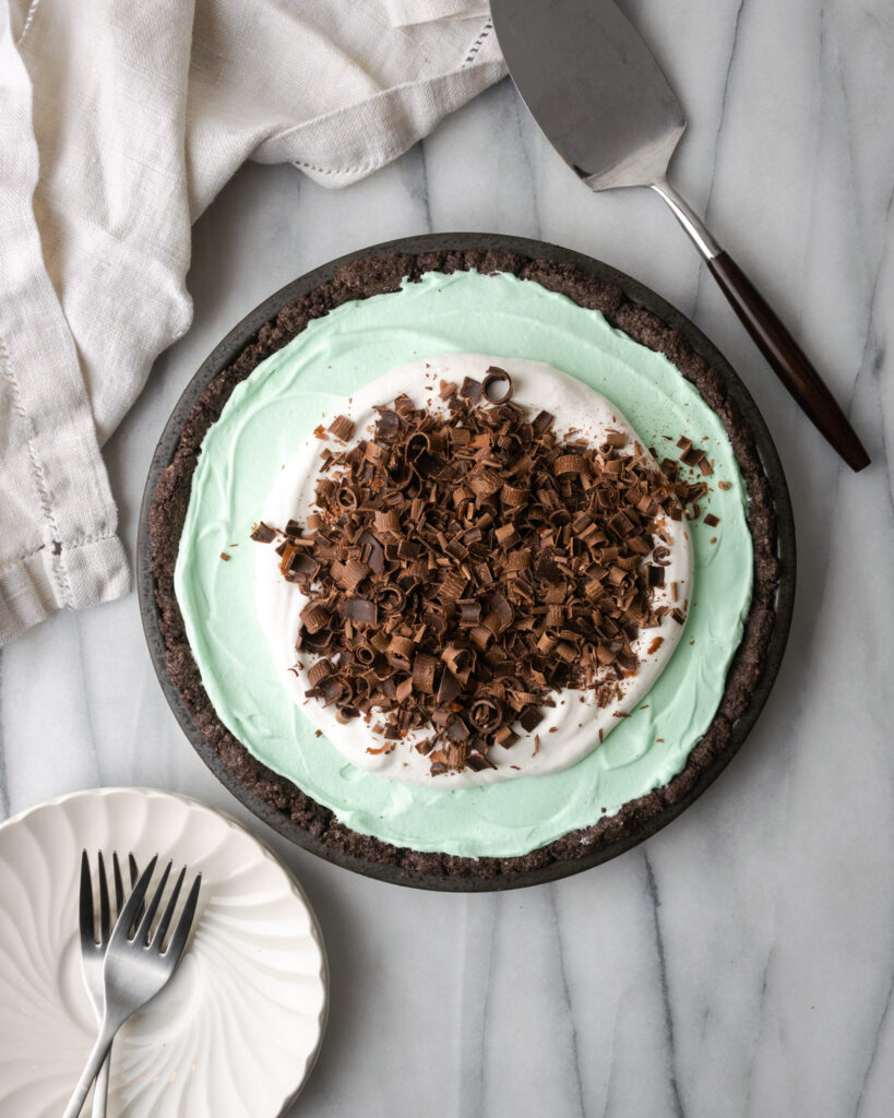 Mint chocolate icebox pie on a white marble table.
