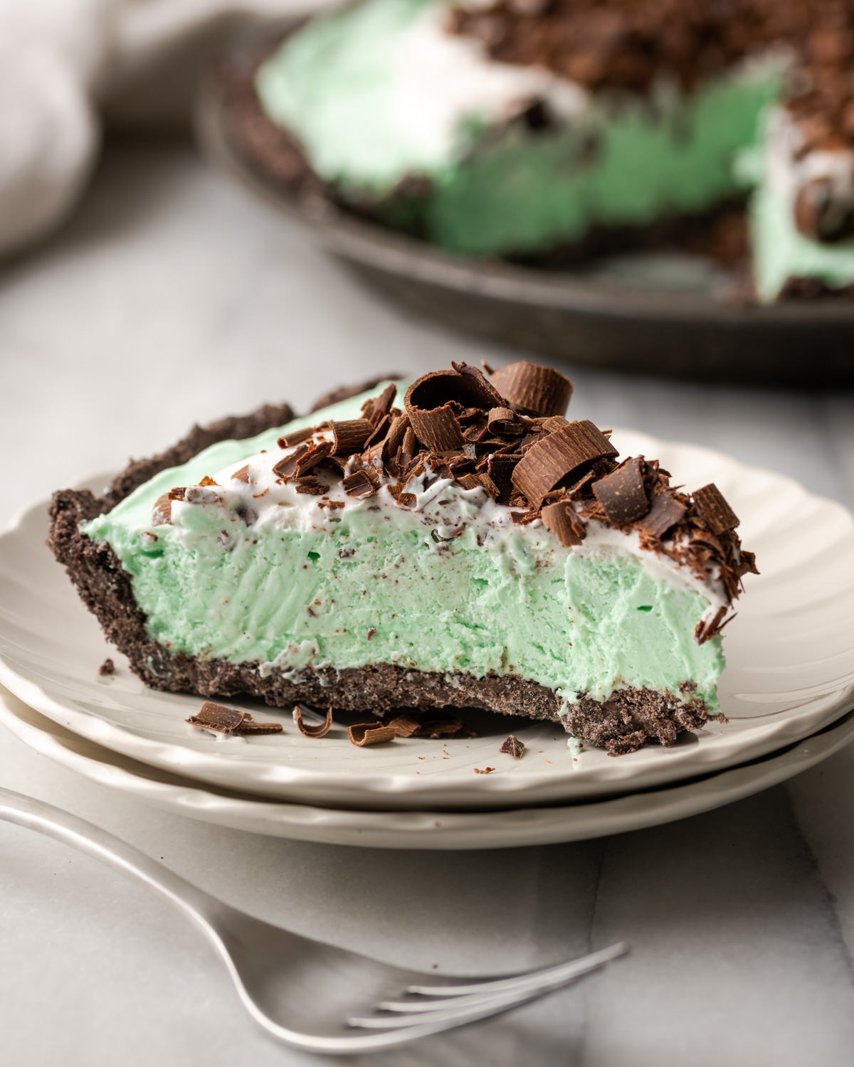 Slice of mint pie on a white plate.
