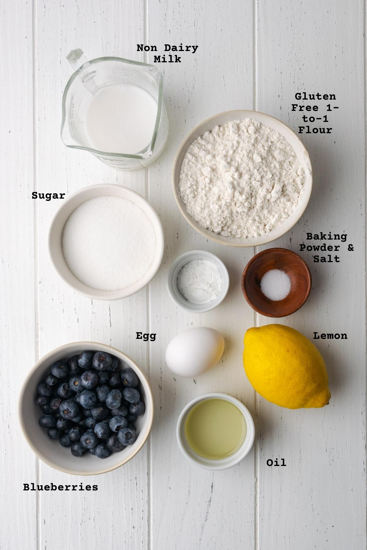 Ingredients for gluten free lemon blueberry muffins on a white table.