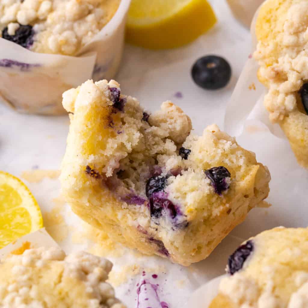Closeup of a lemon blueberry muffin with a bite taken out.
