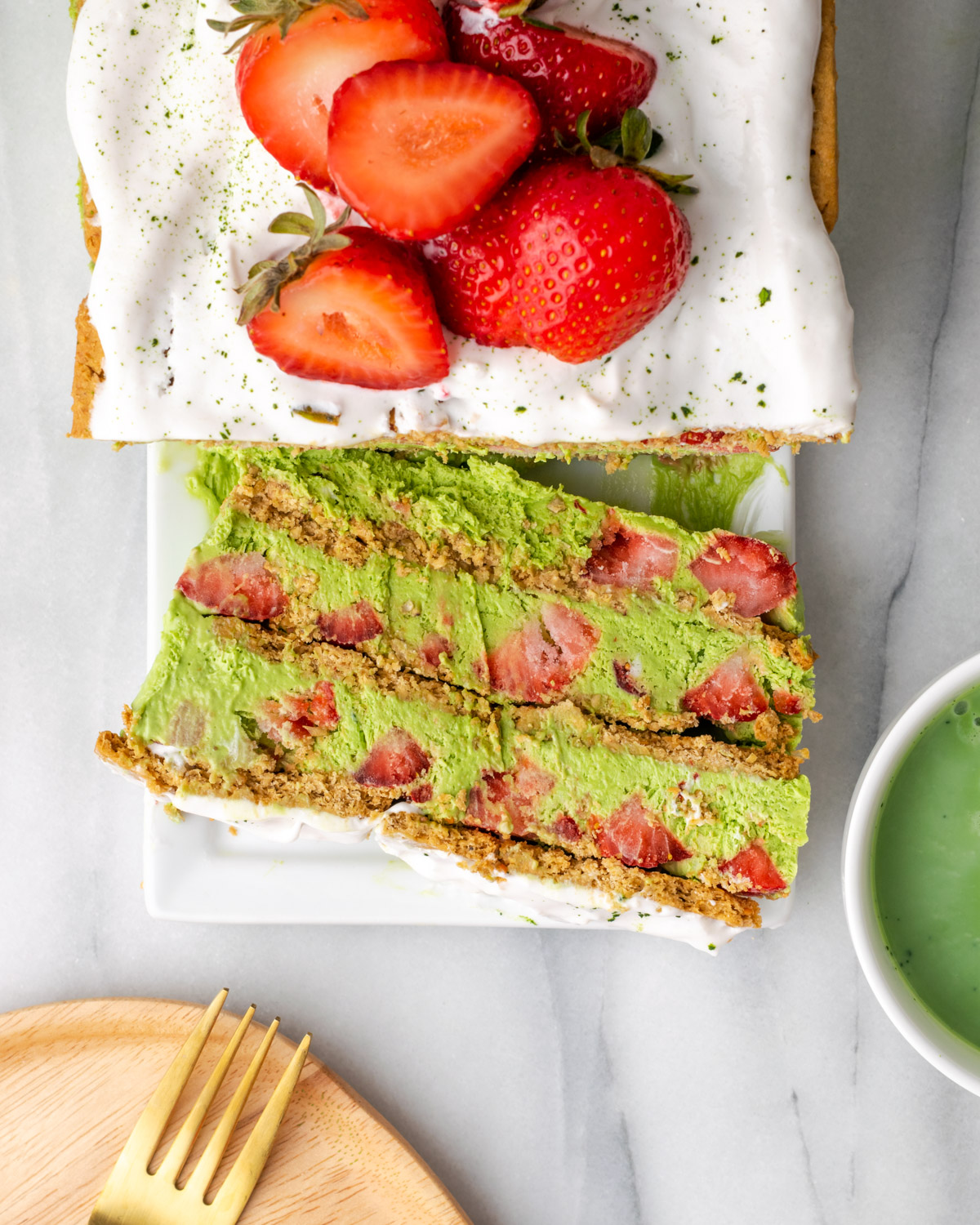 Overhead view of sliced strawberry matcha icebox cake.